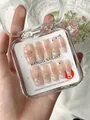 Detail of handmade press-on nails with 3D roses, pearls and rhinestones in a clear box - XS / Peninsula Love Letter-Medium Trapezoid