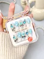 Close-up of handmade 3D light blue coffin press-on nails with bows and heart gems - XS / Devil's Eye (K06)