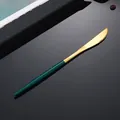 Coltello da bistecca moderno in acciaio dorato con manico verde bosco su sfondo nero - Coltello da Tavola Verde Scuro Oro