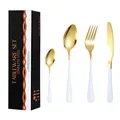 16-piece stainless steel cutlery set with white handles and gold finish in a black gift box - Platinum
