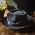 British style wool fedora hat with paisley ribbon and flat bow on wooden surface - L / Black