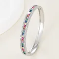 Macro detail of silver bangle with rainbow square-cut gems and micro-pave crystals - Silver - Multicolor Zirconia