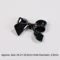 Detail of macaron bow bead with iridescent finish measuring 24.3x33.6mm and 2.9mm hole - Black