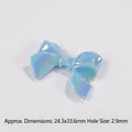 Detail view of light blue iridescent bow bead showing dimensions 24.3x33.6mm for DIY crafts - Size approx 24.3x33.6x7.8mm, Hole approx 2.9mm / Blue