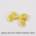 Macro detail of yellow macaron bow bead showing polarized coating and 2.9mm hole diameter - Yellow