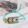Detail of handmade woven Miyuki bead bracelet featuring a cartoon Madonna icon with blue cord - Green