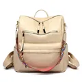 Beige faux leather backpack featuring a stylish geometric woven strap and gold zippers - Beige