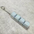 Stress relief keychain with 4 light blue mechanical keys on a clear acrylic base - 4-Key Transparent Shell Blue