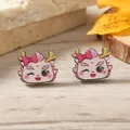 Close-up of cute cartoon dragon earrings with pink bows on a natural wooden background - Winking Pink Little Dragon Style (WEH4274) / Pink