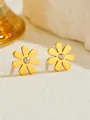 Macro shot of gold-plated daisy earrings with center zircon on a textured stone surface - Little Daisy Stud Earrings (E196) / Gold