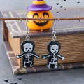Detailed view of Halloween skeleton earrings with black cloaks on a festive background - Black and White Skeleton Style (WEH1622)