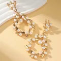 Elegant gold bow-shaped wreath earrings with white pearls for women in classic style - Hollow Flower Wreath Gold