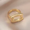 Elegant gold hollow rectangle open ring with textured finish on champagne silk background - KC Gold Geometric Rectangle Style (WR1095)