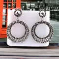 Detail view of large circular drop earrings featuring gunmetal grey pavé rhinestones - Large Hoop Drop / Bright Black Antique Silver