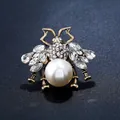 Macro shot of vintage gold bee brooch with large pearl and sparkling rhinestones - X084 White Vintage Bee Design (Antique KC Gold) / Brooch