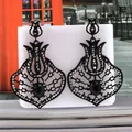 Detailed view of vintage black tulip hollow earrings with grey zircon and oval gemstone - Bright Black Swim Black