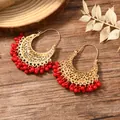 Detail view of gold-plated crescent earrings with red bead fringes and filigree metalwork - Red Bead Tassel Style (WEH1926 Red Gold)
