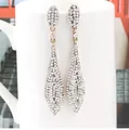 Elegant silver-tone long drop earrings with white crystal pave on a ceramic mug - White Antique KC Gold