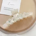 Elegant white acetate hair claw clip featuring delicate rhinestone flowers for women - 11cm / Mermaid White