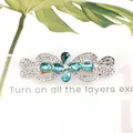 Elegant rhinestone hair clip with teal floral crystal in a bow knot design - Cross Knot Blue
