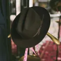 Classic dark brown wool felt Fedora hat with ribbon trim on vintage gold coat rack - Army Green