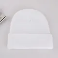 Dettaglio del berretto in maglia a coste bianco con risvolto per calore invernale - Bianco
