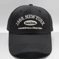 Detailed close-up of 1989 New York white embroidery on black cotton baseball cap - M (56-58cm) / Black