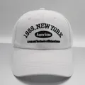 Detailed view of white cotton baseball cap featuring 1989 New York black embroidery - M (56-58cm) / White