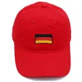 Red cotton baseball cap featuring embroidered Germany flag on front panel - Red