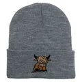 Detailed close-up of dark grey knitted beanie featuring a highland cow embroidery - Stretchy / Medium Heather Grey