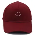 Burgundy cotton baseball cap featuring a white embroidered smiley face on the front - M (56-58cm) / Burgundy