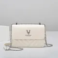 Detail of cream crossbody bag with silver deer logo and elegant V-shaped quilting - Beige