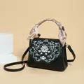 Elegant black leather handbag with pink floral embroidery and silk scarf handle - Black
