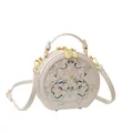 Ivoren ronde crossbodytas met elegant bloemenborduurwerk en gouden accenten - Rijstroze