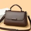 Minimalistische donkerbruine crossbodytas met litchi-textuur en zilveren accenten - koffiekleur