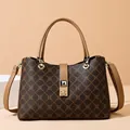 Vintage patterned tote bag with brown contrast leather handles and gold lock buckle - Monogram