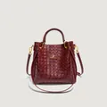 Elegant deep red woven bucket bag with dual handles and gold-tone metallic logo hardware - Cross Woven Style / Woven Red