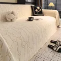 Detailed view of cream jacquard sofa cover with geometric texture and fringe tassels - 180*130 / Off White