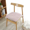Light pink quilted cotton chair pad with ties in a cozy minimalist Nordic home setting - Checkered Pink