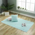 Detailed close-up of thick light blue plush rug with soft texture and white stitched edge - 45cmx45cm / Chair Pad / Lake Blue