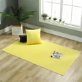 Close-up of bright yellow plush faux rabbit fur rug with durable white cloth edging - 70x70cm / Bright Yellow