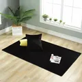 High-angle view of a plush solid black rectangle carpet in a cozy bedroom setting - 70cmx70cm / Pure Black