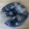 Close-up of a round Japanese patchwork seat cushion with plaid textures and tufted buttons - New Pattern-02