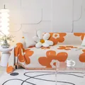 Detail of cream sofa cover with orange floral patterns and fringed tassel edges - 180*130 / White with Orange Flowers