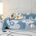 Blue knit sofa cover with white floral pattern and tassel edges in modern living room - Blue White Floral