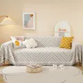 Housse de canapé géométrique gris clair avec pompons et motif en losange nordique - 180x130 / Gris clair