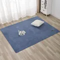 Detail of soft blue faux lamb wool rug with leather tag on light wooden floor - 70x180cm / Blue