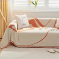 Chenille sofa cover with orange wave patterns and fringe tassels for cat protection - Honey Orange
