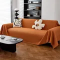 Funda de sofá tipo gofre en naranja caramelo con flecos para salón moderno - Caramelo