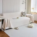 Beige woven sofa cover blanket with wavy texture and fringe trim on a three-seater sofa - 180*150 / Beige